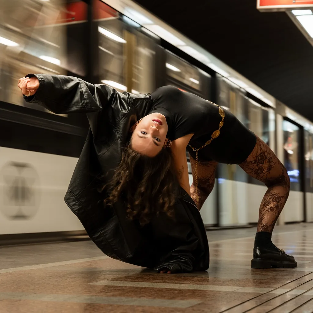 Dancer arching backward on a metro platform