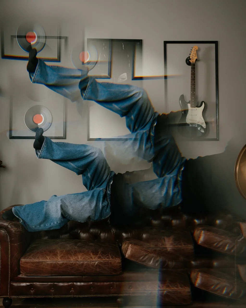 Layered motion portrait of a dancer beside a leather sofa